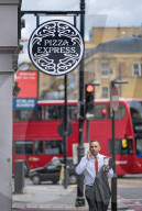 Pizza Express wipes Â£400m off the debt bill in rescue deal. Former Asda boss Allan Leighton becomes chairman of the troubled restaurant chain that has secured a restructuring deal