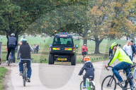 Members of the public go out for a Sunday walk and cycle in a packed Richmond Park in South West London as Police patrol the park.