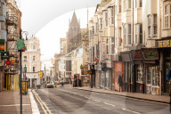 Covid lockdown two: coffee queues, traffic jams, staring at shops and boredom. On a sodden seafront in Hove, East Sussex, walkers look for respite from the latest coronavirus restrictions