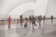 Covid lockdown two: coffee queues, traffic jams, staring at shops and boredom. On a sodden seafront in Hove, East Sussex, walkers look for respite from the latest coronavirus restrictions