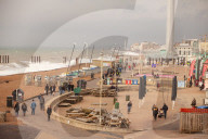 Covid lockdown two: coffee queues, traffic jams, staring at shops and boredom. On a sodden seafront in Hove, East Sussex, walkers look for respite from the latest coronavirus restrictions