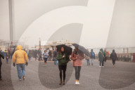 Covid lockdown two: coffee queues, traffic jams, staring at shops and boredom. On a sodden seafront in Hove, East Sussex, walkers look for respite from the latest coronavirus restrictions