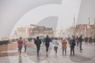 Covid lockdown two: coffee queues, traffic jams, staring at shops and boredom. On a sodden seafront in Hove, East Sussex, walkers look for respite from the latest coronavirus restrictions