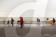Covid lockdown two: coffee queues, traffic jams, staring at shops and boredom. On a sodden seafront in Hove, East Sussex, walkers look for respite from the latest coronavirus restrictions