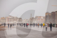 Covid lockdown two: coffee queues, traffic jams, staring at shops and boredom. On a sodden seafront in Hove, East Sussex, walkers look for respite from the latest coronavirus restrictions