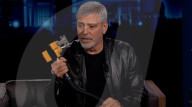 George Clooney demonstrates the hair cutter he has been using to keep trim during lockdown