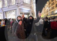 A large crowd of young people outside Harrods, Knightsbridge, London.