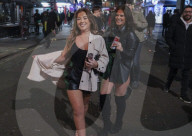 Christmas revellers make the most of the last night of bars being open before London is moved to Tier 3 restrictions.