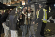 Christmas revellers make the most of the last night of bars being open before London is moved to Tier 3 restrictions.