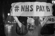 A grassroots campaign, NHS Workers say No, demonstrate in front of Downing Street.