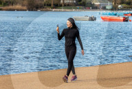 Londoners bask in unseasonally warm weather as UK Covid-19 threat level lowered