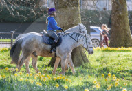 Londoners bask in unseasonally warm weather as UK Covid-19 threat level lowered