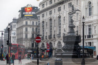 A government Covid-19 information sign high above Piccadilly Circus.