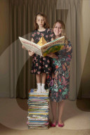 We read books to my daughter from birth, which enriched all our lives. Donna and Flora Ferguson holding an open children's book. ‘She is nine years old now and an avid book reader’:  A difficult pregnancy meant the only item I dared buy for my unborn c