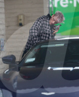 Machine Gun Kelly is seen filing up his Aston Martin at a gas station in Thousand Oaks on Wednesday afternoon. 