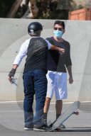 Simon Cowell and his girlfriend Lauren Silverman take their 7-year-old son Eric to a skatepark in Malibu. 