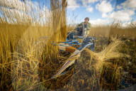 Reed cutters on the Norfolk Broads keeping the rural tradition alive supplying reeds to make thatched roofs.
