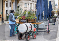 Workmen prepare restaurants and non-essential shops in Covent Garden, London. 