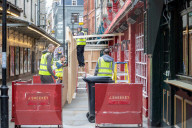 Workmen prepare restaurants and non-essential shops in Covent Garden, London. 