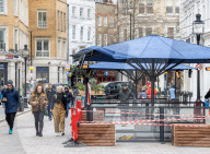 Workmen prepare restaurants and non-essential shops in Covent Garden, London. 