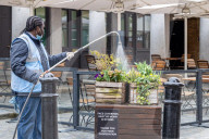 Workmen prepare restaurants and non-essential shops in Covent Garden, London. 