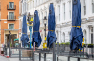 Workmen prepare restaurants and non-essential shops in Covent Garden, London. 