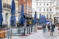 Workmen prepare restaurants and non-essential shops in Covent Garden, London. 