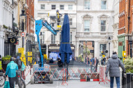 Workmen prepare restaurants and non-essential shops in Covent Garden, London. 