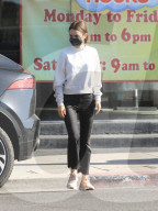 PREMIUM EXCLUSIVE Lily Collins Looks Super Cute In Black Denim And White Sweater