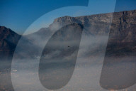 Smoke Haze over Cape Town as fire fighters and helicopters battle with flare ups on day 3 of the Table Mountain Fire.