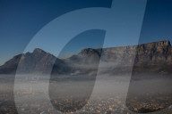Smoke Haze over Cape Town as fire fighters and helicopters battle with flare ups on day 3 of the Table Mountain Fire.