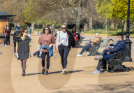Members of the public enjoy the sunshine in Hyde Park.