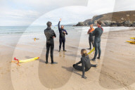 ‘Respect the water’: RNLI lifeguard training in Cornwall. Ahead of a busy summer of domestic tourism in the UK, qualified lifeguards and trainees rehearse life-saving procedures