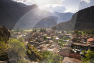 Ollantaytambo Inca Ruins at sunset seen behind Ollantaytambo Town, Sacred Valley of the Incas, near Cusco, Peru