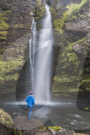Tourist at Gluggafoss (Window Falls aka Merkjarfoss), a waterfall on the Merkja River, South Iceland (Sudurland)