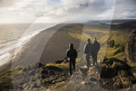 Tourists looking at the view at sunset from Dyrholaey Peninsula, near Vik, South Iceland (Sudurland)