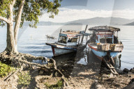 Old rusty fishing boats in a village at Lake Toba (Danau Toba), North Sumatra, Indonesia