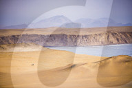 Hikers hiking in desert and sand dunes, Paracas National Reserve (Reserva Nacional de Paracas), Ica, Peru