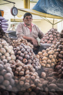 Portrait of potato vendor at his market stall at San Camilo Market (Mercado San Camilo), Arequipa, Peru