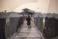 Buddhist Monk on U Bein Teak Bridge at sunrise, Mandalay, Mandalay Region, Myanmar (Burma)