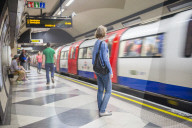 Person waiting at Waterloo underground station for the tube, London, England, United Kingdom, Europe