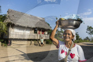 Woman carrying food in bowl, San Miguel CaÃ±o, Upper Amazon River Basin, Loreto, Peru