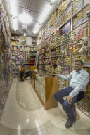 Seated shopkeepers in a brocade shop at Mutrah Souq, Muscat, Oman, Middle East