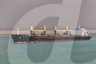 Ship transits the Suez Canal with sandy desert backdrop, Great Bitter Lake, near Ismalia, Egypt