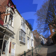Historic buildings line cobbled Steep Hill, voted Britain's Great Street 2012, Cathedral Quarter, Lincoln, Lincolnshire, England