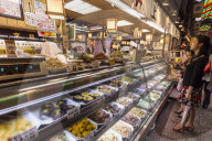 Customers wait at counter of local Japanese food stall, Nishiki Market (Kyoto's Kitchen), Downtown Kyoto, Japan