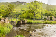 Bridge across River Wye, stone farm buildings, Monsal Dale, spectacular limestone scenery, Peak District, Derbyshire, England, United Kingdom, Europe
