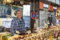 Smiling charcuterie stall holder, Marche Provencal, morning market, Vieil Antibes, French Riviera, Cote d'Azur, Provence, Fr