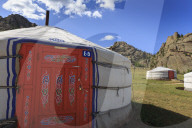 Tourist ger camp in front of rocky outcrop in fine weather, Summer, Terelj National Park, Central Mongolia