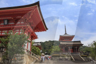 Visitors with sun umbrella, vermillion temple entrance buildings, Kiyomizu-dera, Summer, Southern Higashiyama, Kyoto, Japan